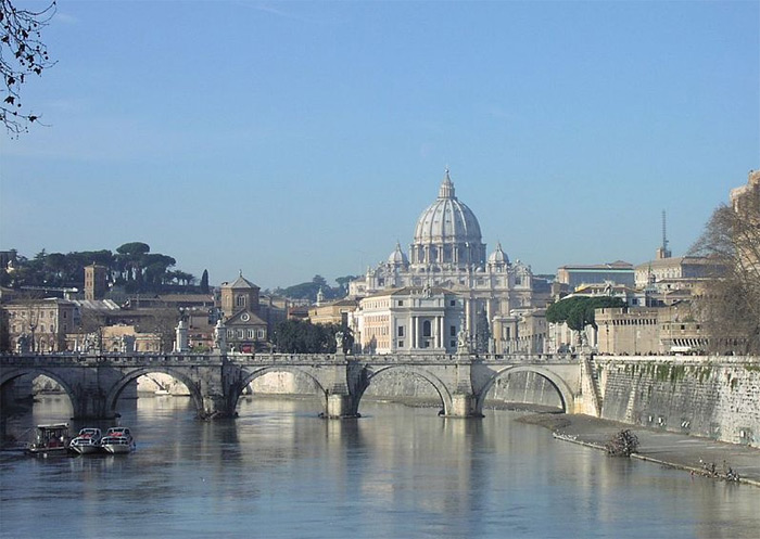 St. Peter's Basilica, believed to be the burial site of St. Peter, seen from the River Tiber. The iconic dome dominates the skyline of Rome.